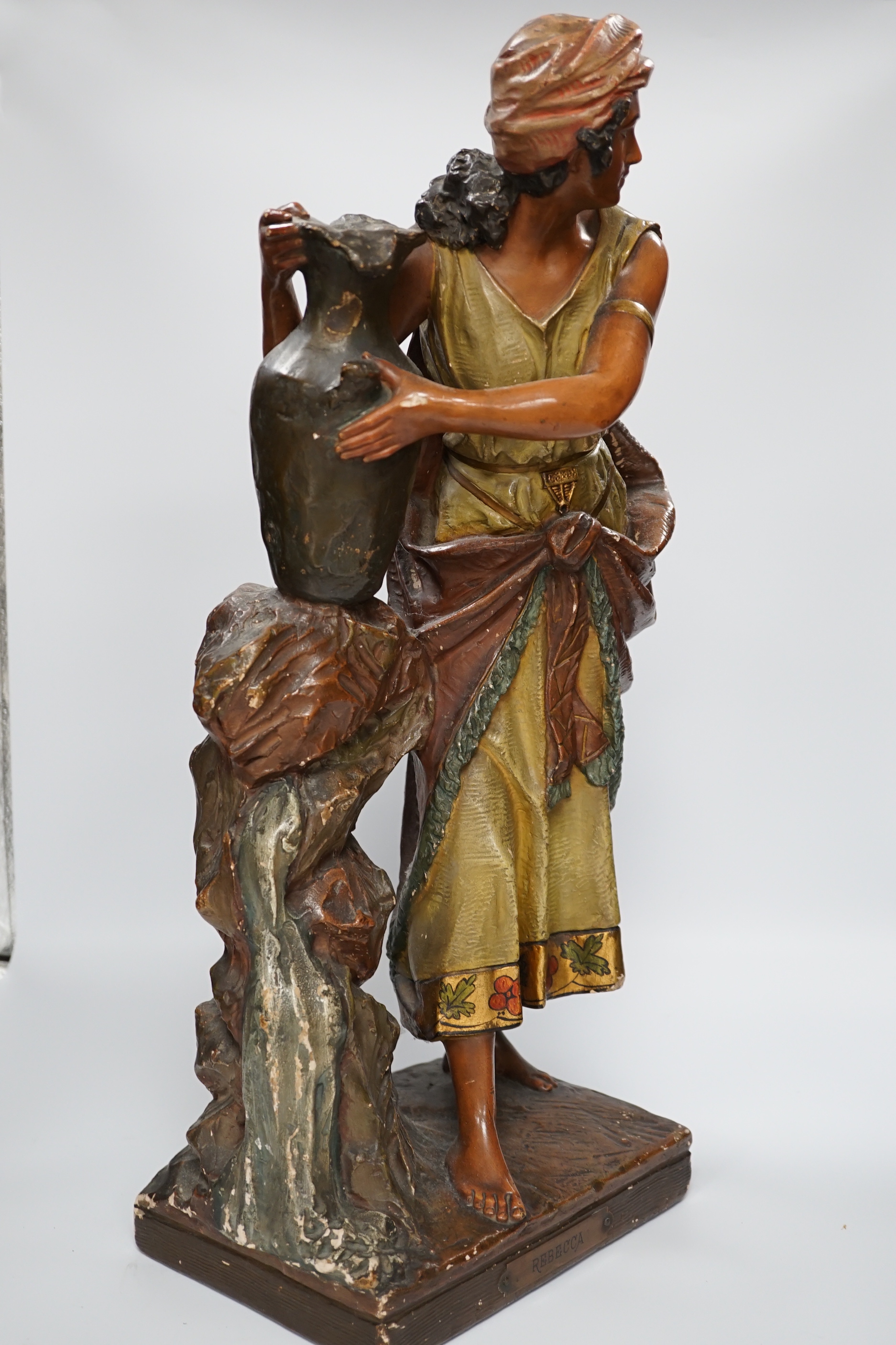 A painted plaster figure of Rebecca at the well, 58cm high